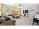 Bright living room with large windows, comfortable seating, and a modern entertainment center at 20812 W Legend Trl, Buckeye, AZ 85396
