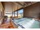 Covered patio with a hot tub, seating, and a view of the fenced backyard at 20812 W Legend Trl, Buckeye, AZ 85396