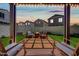 A cozy patio area with a round fire pit surrounded by chairs, perfect for outdoor gatherings at 20812 W Legend Trl, Buckeye, AZ 85396