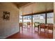 View of the covered patio area, with dining, seating, and a beautiful green lawn at 20812 W Legend Trl, Buckeye, AZ 85396