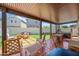 Relaxing covered patio area with dining set, a barrel fire pit, and green turf at 20812 W Legend Trl, Buckeye, AZ 85396