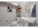 Stylish powder room featuring modern fixtures, decorative accents, and a pedestal sink at 20812 W Legend Trl, Buckeye, AZ 85396