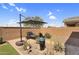 Serene backyard with lounge chair, umbrella, water feature and beautiful desert landscaping at 22560 E Rosa Rd, Queen Creek, AZ 85142