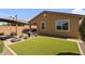 Backyard features a small patio, desert landscaping and artificial grass at 22560 E Rosa Rd, Queen Creek, AZ 85142