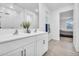 Bright bathroom featuring dual sinks, white cabinets, and walk in shower with glass door at 22560 E Rosa Rd, Queen Creek, AZ 85142