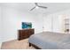 Bright bedroom featuring a ceiling fan, carpet, and TV on a wooden dresser at 22560 E Rosa Rd, Queen Creek, AZ 85142