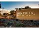 Queen Creek Marketplace entrance featuring lush desert landscaping and clear signage at 22560 E Rosa Rd, Queen Creek, AZ 85142