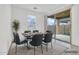 Dining room with large glass sliding door and a modern table with seating for six at 22560 E Rosa Rd, Queen Creek, AZ 85142