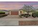 Inviting single-story home with a brown garage door, desert landscaping, and charming curb appeal at 22560 E Rosa Rd, Queen Creek, AZ 85142
