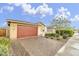 Inviting home exterior with a spacious driveway and meticulously maintained landscaping at 22560 E Rosa Rd, Queen Creek, AZ 85142
