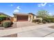 Charming single-story home with a brick driveway, well-maintained landscaping, and an attached garage at 22560 E Rosa Rd, Queen Creek, AZ 85142