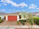 Beautiful single-story home with a red garage door, desert landscaping, and paver driveway at 22560 E Rosa Rd, Queen Creek, AZ 85142
