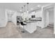 Bright kitchen with white cabinets, granite countertops, stainless steel appliances, and an island with seating at 22560 E Rosa Rd, Queen Creek, AZ 85142