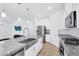 Modern kitchen with stainless steel appliances, granite countertops, and a stylish farmhouse sink at 22560 E Rosa Rd, Queen Creek, AZ 85142