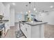 Well-lit kitchen featuring granite countertops, stainless steel sink, and a view of the living room at 22560 E Rosa Rd, Queen Creek, AZ 85142