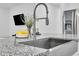 Close up of granite countertop, with view of stainless steel sink, faucet, lemons, and stainless refrigerator at 22560 E Rosa Rd, Queen Creek, AZ 85142
