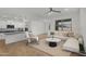 Bright living room with tile flooring, a modern ceiling fan, and stylish contemporary furniture at 22560 E Rosa Rd, Queen Creek, AZ 85142