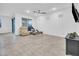 Bright living room featuring neutral tile flooring, multiple windows and sliding glass door at 22560 E Rosa Rd, Queen Creek, AZ 85142