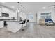 Open-concept living space with sleek countertops, modern stools and comfortable seating area at 22560 E Rosa Rd, Queen Creek, AZ 85142