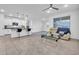 Inviting living space featuring an open kitchen, a cozy sofa, and tile flooring at 22560 E Rosa Rd, Queen Creek, AZ 85142