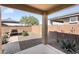 Relaxing covered patio with lounge seating, landscaped area, and a brick privacy wall at 22560 E Rosa Rd, Queen Creek, AZ 85142