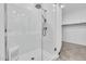 Close-up of a glass enclosed shower with a built in seat and rainfall shower head at 22560 E Rosa Rd, Queen Creek, AZ 85142