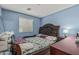 Inviting bedroom with a statement headboard, colorful bedding, and soft lighting, providing a comfortable retreat at 2559 N 73Rd Dr, Phoenix, AZ 85035