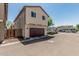 Beige two-story home featuring a two-car garage and well-maintained landscaping, offering a modern and inviting curb appeal at 2559 N 73Rd Dr, Phoenix, AZ 85035