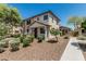Charming two-story townhome with a covered entryway, desert landscaping, and a view of the neighborhood at 2559 N 73Rd Dr, Phoenix, AZ 85035