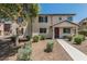 Inviting two-story townhome featuring neutral stucco, dark shutters, and well-maintained front yard landscaping at 2559 N 73Rd Dr, Phoenix, AZ 85035