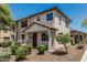 Attractive two-story townhome with desert landscaping, covered porch, and a glimpse of the neighborhood at 2559 N 73Rd Dr, Phoenix, AZ 85035
