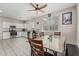Bright and airy kitchen and dining area with white cabinetry and granite counters overlooking the dining area at 2559 N 73Rd Dr, Phoenix, AZ 85035