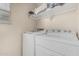 Functional laundry room featuring a side by side washer and dryer and storage shelf, enhancing convenience at 2559 N 73Rd Dr, Phoenix, AZ 85035