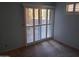 Bedroom featuring sliding glass door and window with white shutters, offering natural light at 3031 N Civic Center Plz # 113, Scottsdale, AZ 85251