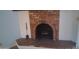 Living room fireplace featuring brick surround and stone hearth at 3031 N Civic Center Plz # 113, Scottsdale, AZ 85251