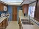 Galley kitchen with white appliances, light countertops, and oak wood cabinetry at 3031 N Civic Center Plz # 113, Scottsdale, AZ 85251