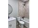 Updated bathroom boasts new tile floors, a new vanity, toilet, and shower with new faucet and new mirror at 3049 W Dahlia Dr, Phoenix, AZ 85029