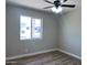 Bright bedroom with wood-look flooring, a ceiling fan and a window bringing in natural light at 3049 W Dahlia Dr, Phoenix, AZ 85029
