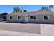 Charming single-story home with freshly painted exterior, updated windows, gravel yard, and manicured landscaping at 3049 W Dahlia Dr, Phoenix, AZ 85029