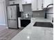 Modern kitchen features stainless steel appliances, quartz countertops, and white cabinets; and under-mount sink and new faucet at 3049 W Dahlia Dr, Phoenix, AZ 85029