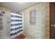 The bathroom features a shower with white and gray striped curtain and floral wallpaper at 3160 E Main St # 110, Mesa, AZ 85213