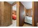 A view into two bedrooms with neutral carpet and wood panel walls at 3160 E Main St # 110, Mesa, AZ 85213