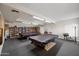 Billiard room featuring two pool tables, shelving with books, and good lighting for hours of recreation at 3160 E Main St # 110, Mesa, AZ 85213