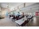 Spacious dining room with tables, chairs, ceiling fans, and ample lighting for large gatherings or community events at 3160 E Main St # 110, Mesa, AZ 85213