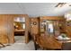 Dining room featuring wood paneling, built-in hutch, and access to bedroom at 3160 E Main St # 110, Mesa, AZ 85213