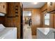 A hallway view of the home with a laundry area and access to other rooms at 3160 E Main St # 110, Mesa, AZ 85213