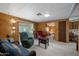 Cozy living room showcasing comfortable seating, light wood paneling, and an open layout at 3160 E Main St # 110, Mesa, AZ 85213