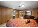 Primary bedroom with wood paneled walls, dresser and en suite bathroom at 3160 E Main St # 110, Mesa, AZ 85213