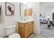 Bathroom featuring wooden vanity, mosaic tile floor, framed mirror and decorative artwork at 3221 E Lynx Pl, Chandler, AZ 85249