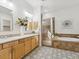 Elegant bathroom boasts double sinks, a soaking tub, a walk-in shower, and decorative tile at 3221 E Lynx Pl, Chandler, AZ 85249
